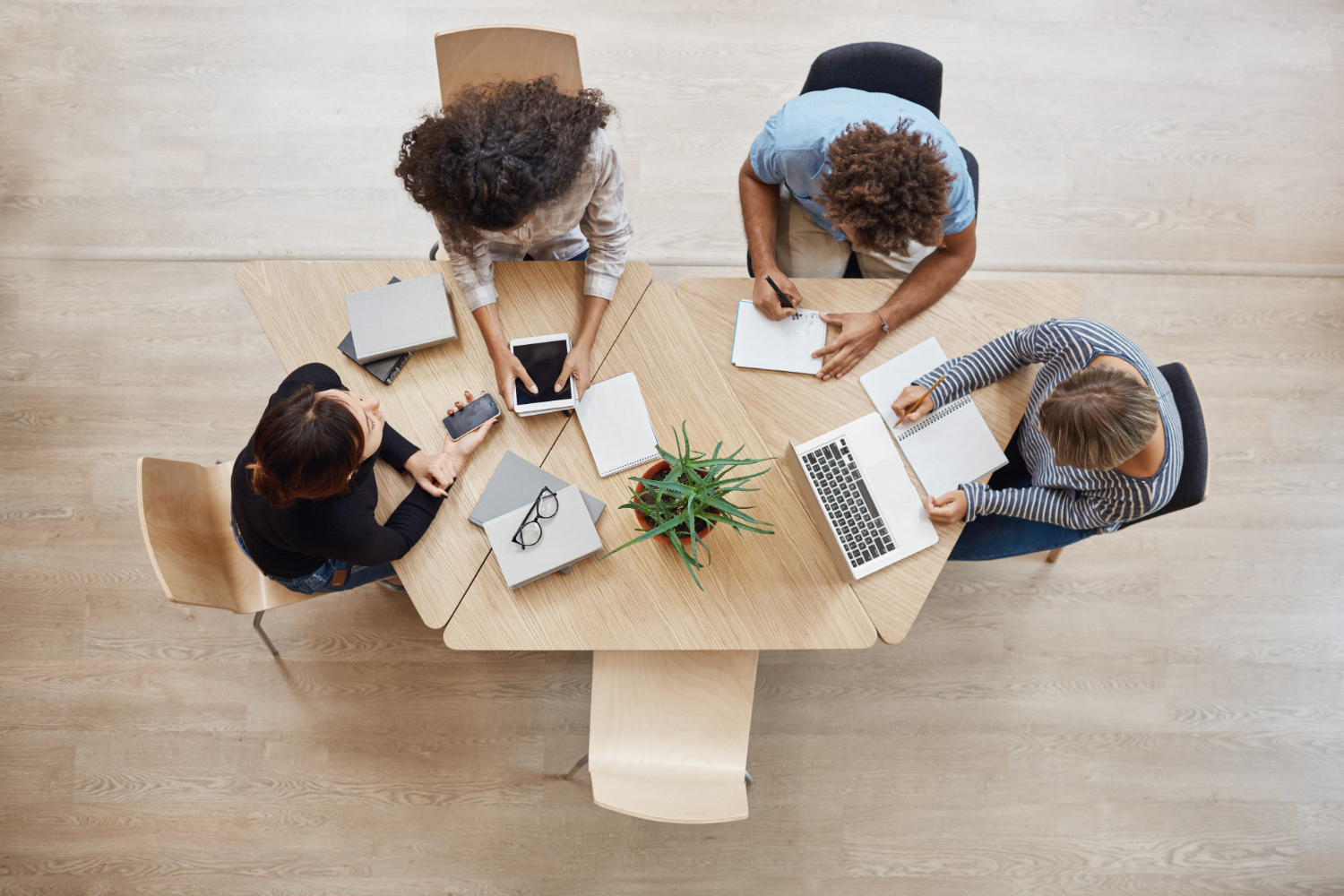 view-from-business-startup-teamwork-concept-startup-partners-sitting-coworking-space-talking-about-future-project-looking-through-examples-work-laptop-digital-tablet